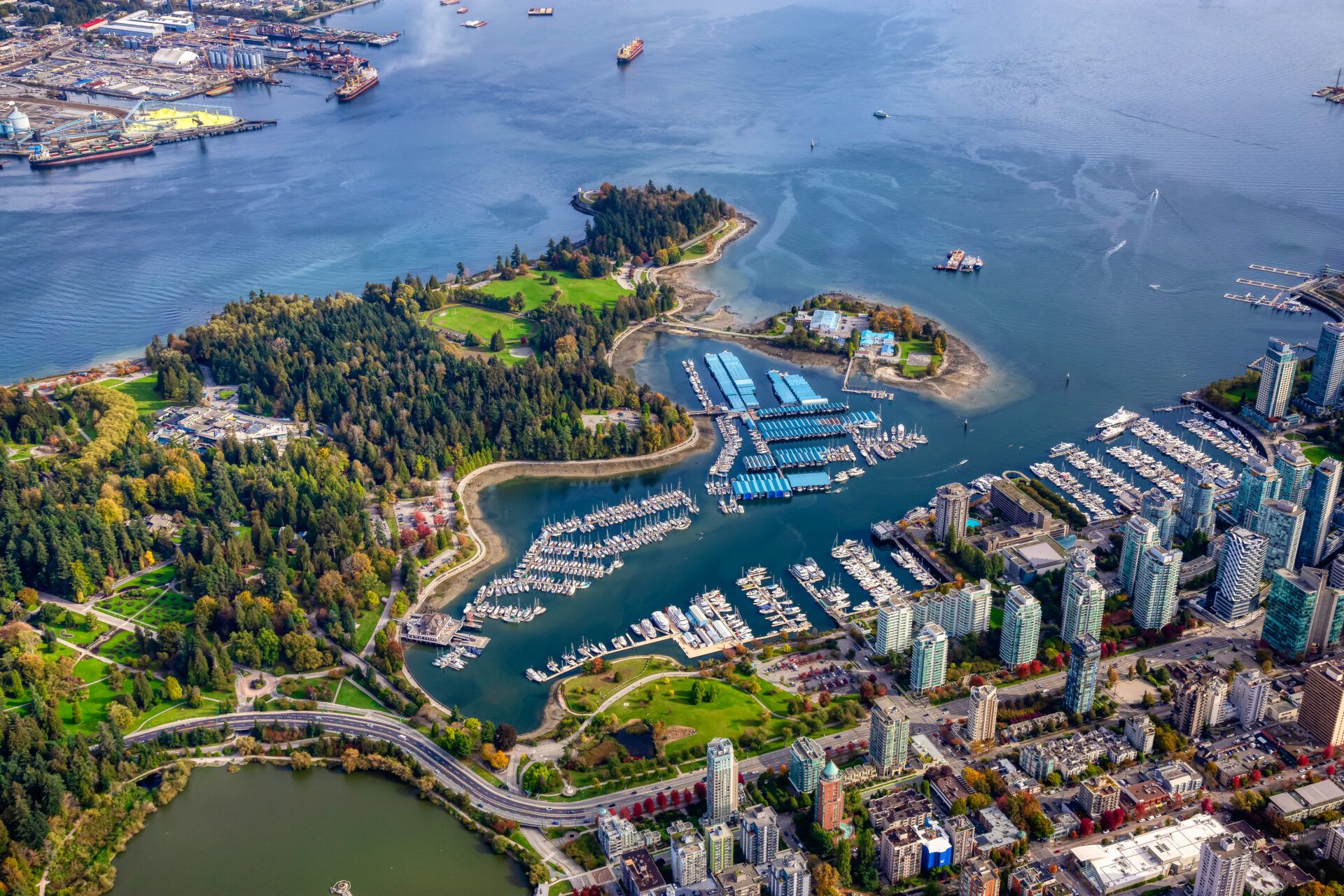 Aerial view of Coal Harbour and a modern Downtown City during a vibrant sunny morning. Taken in Vancouver, British Columbia, Canada.