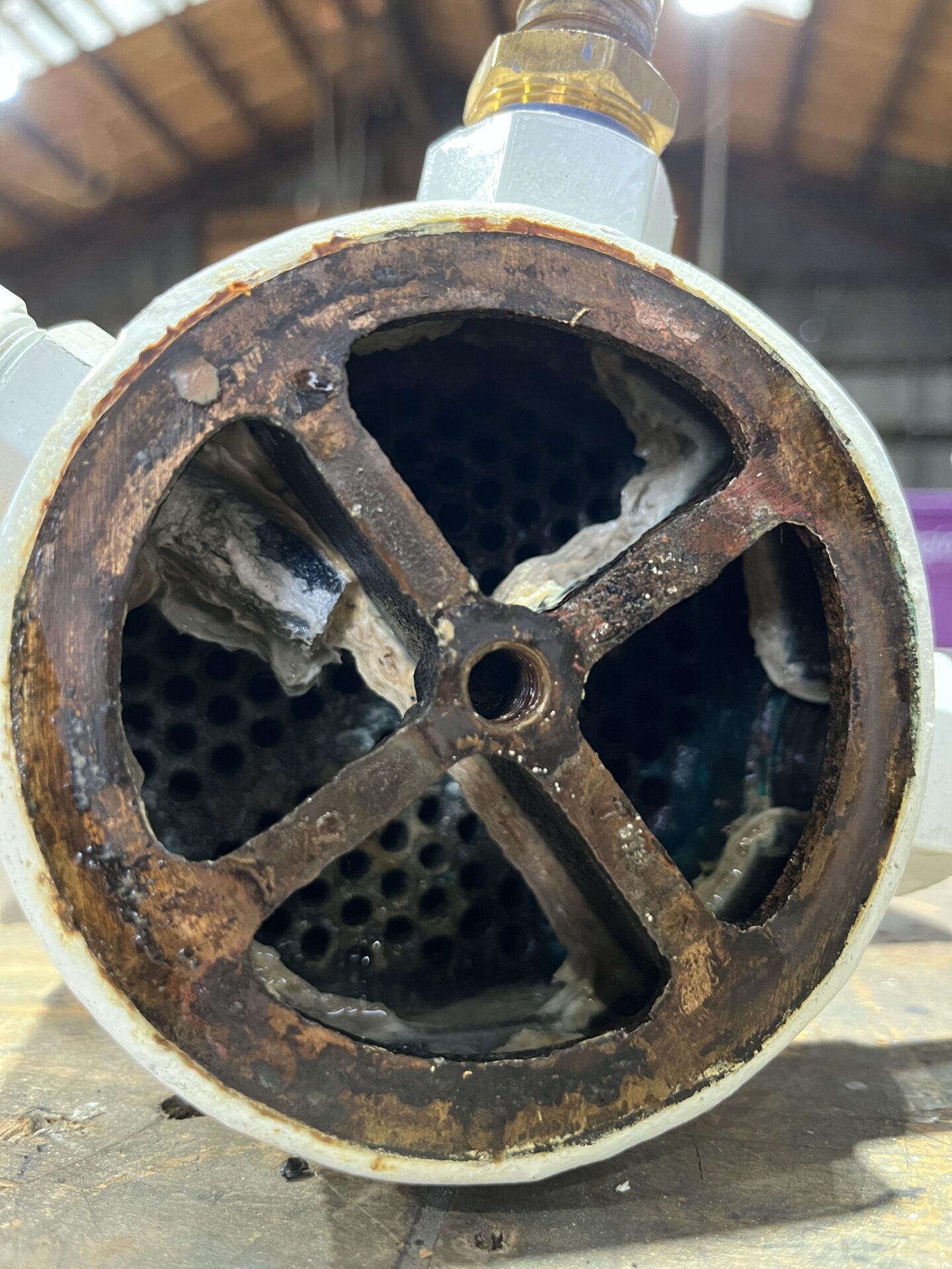 Marine AC heat exchanger with mineral scale and marine growth buildup inside cooling passages