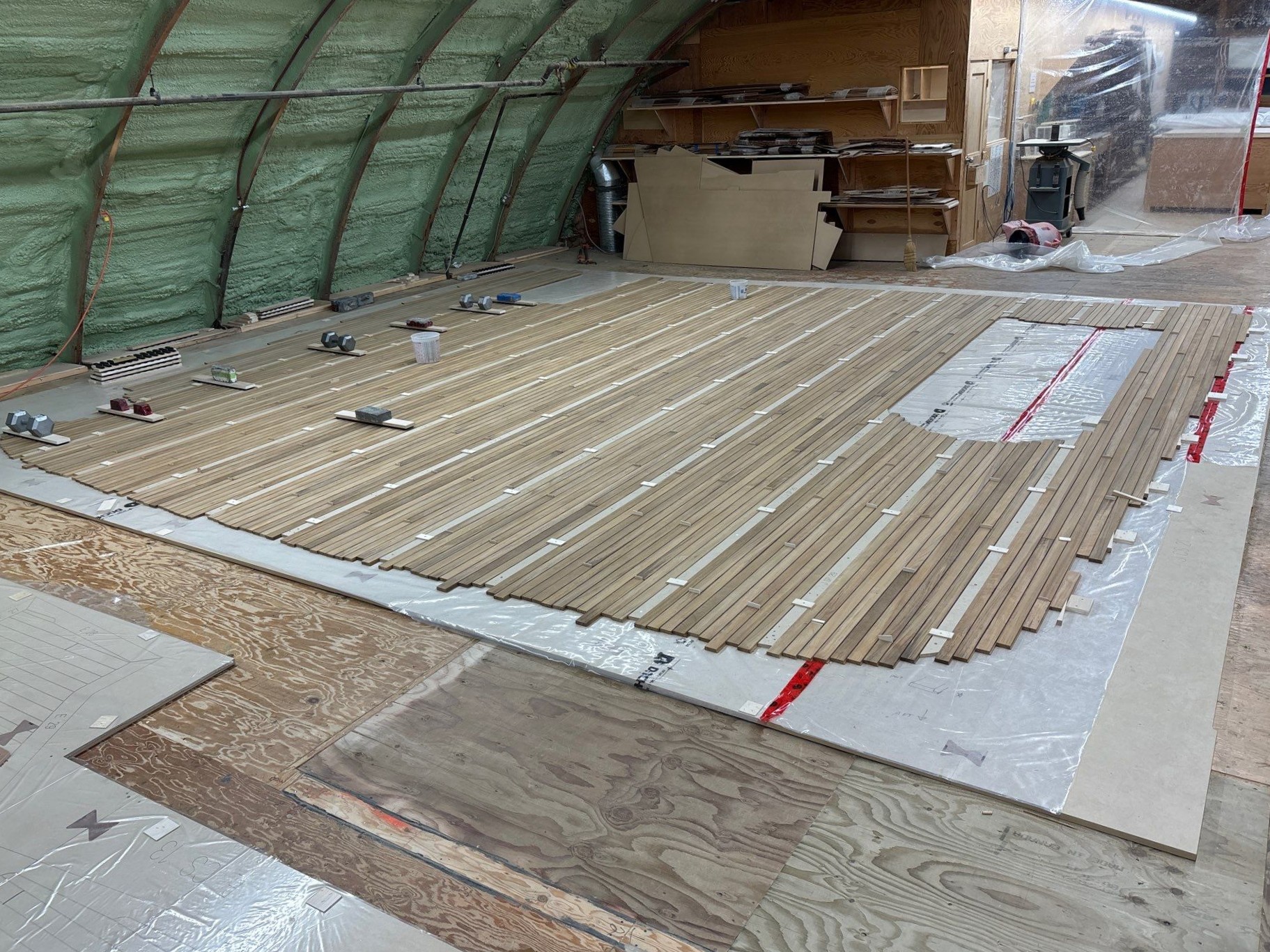 Teak decking strips assembled into sections over full-size templating guides