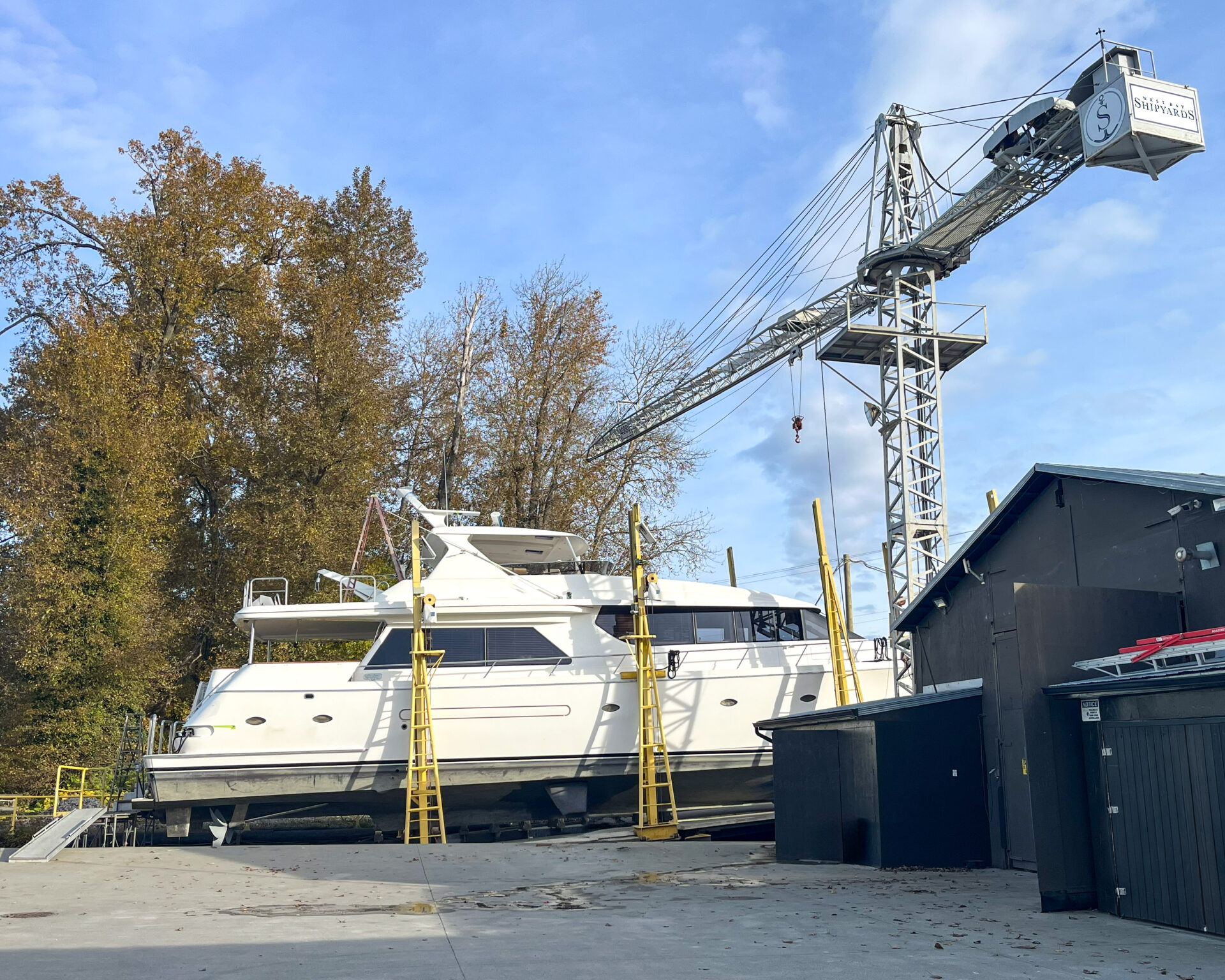 yacht on dry dock with crane waiting for refit work