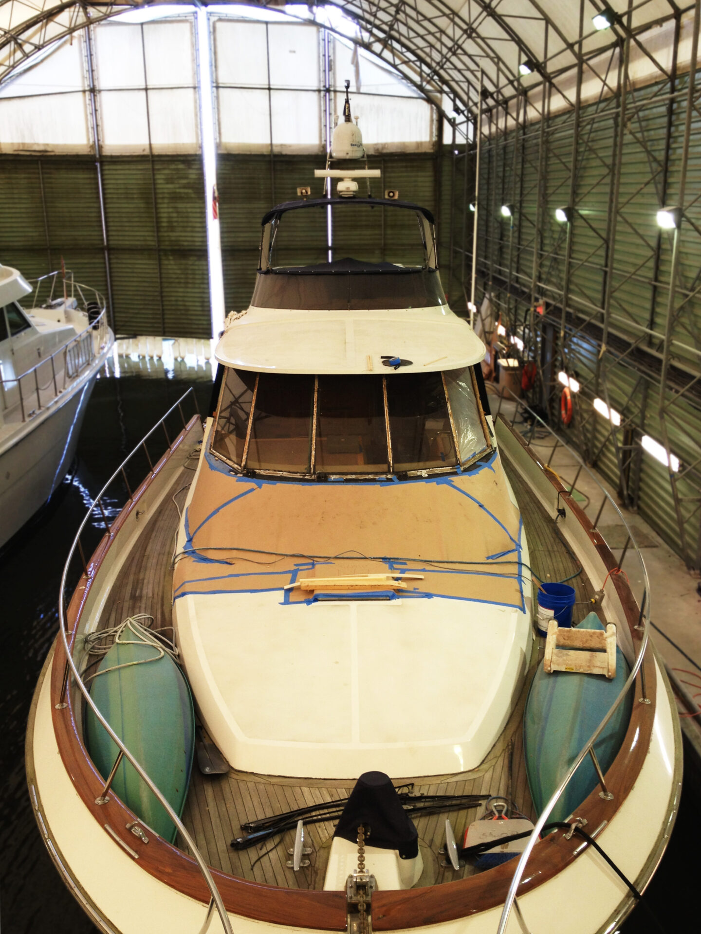 Yacht undergoing maintenance in boathouse storage