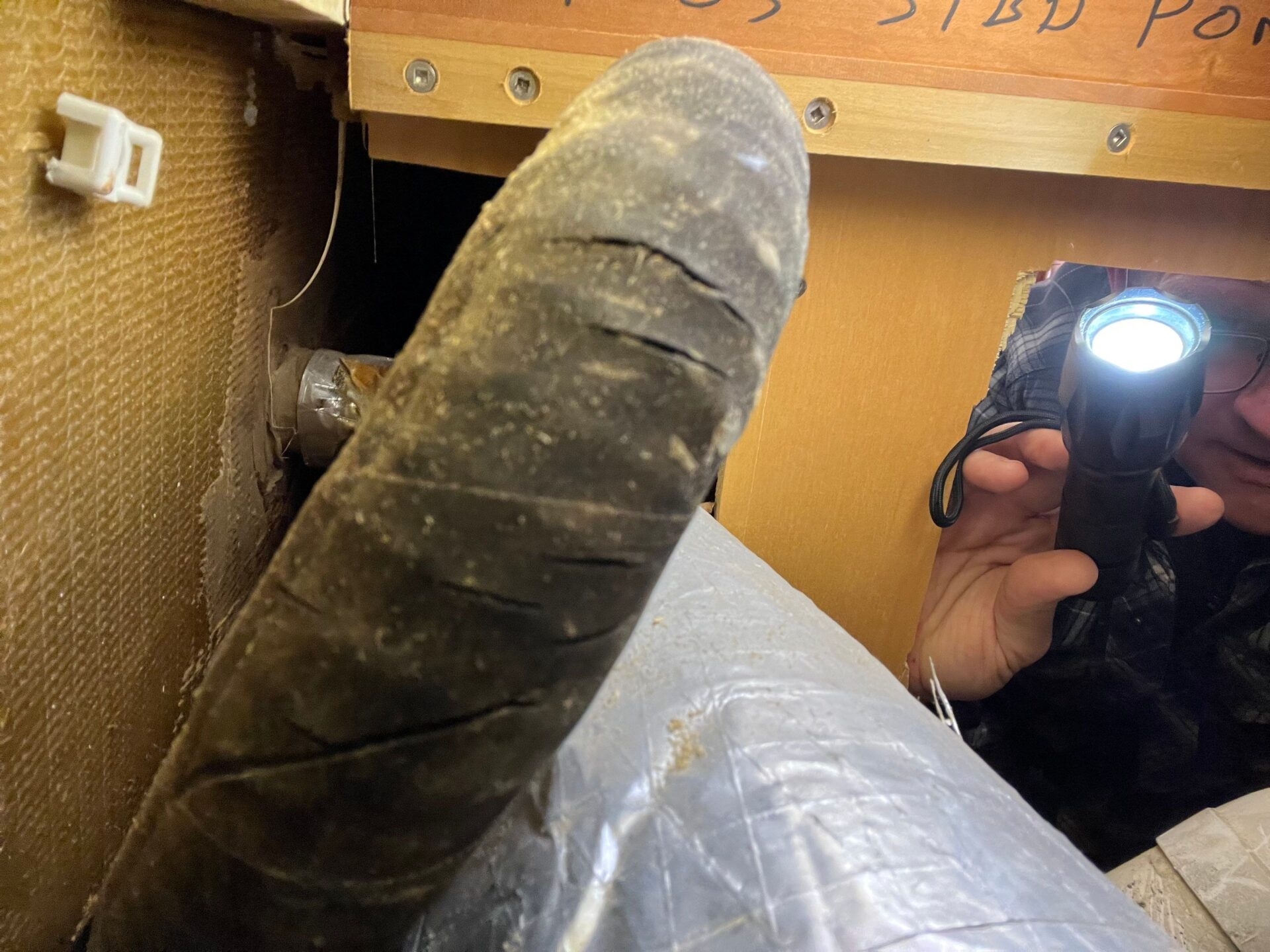 rust staining and corrosion from a pipe leak in a boat engine