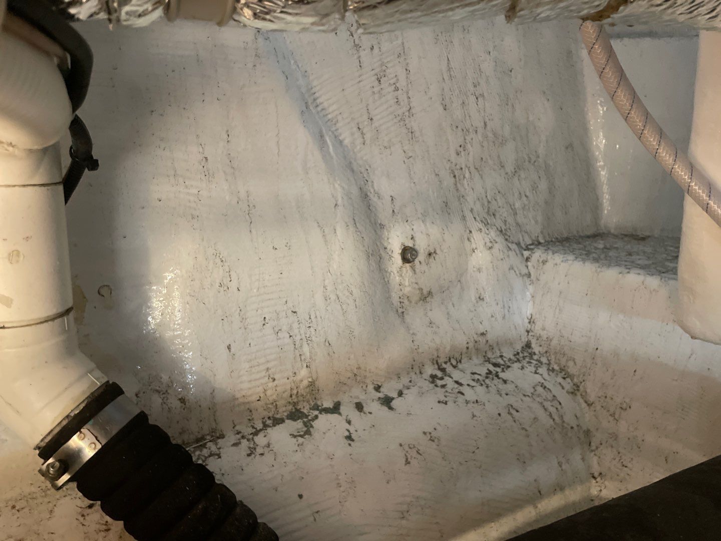 dirt, grime, and potentially mold appearing on white wall of marine engine room