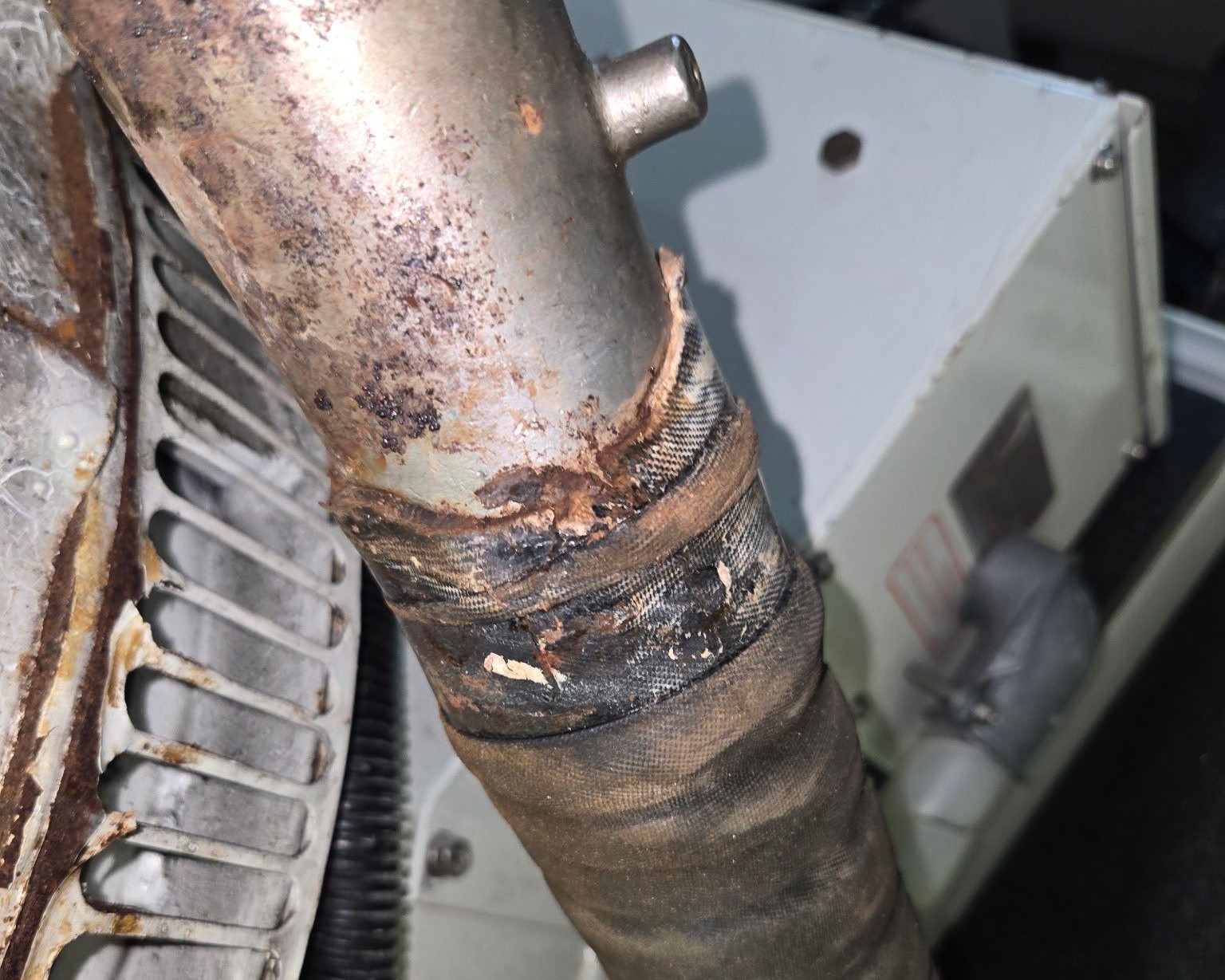 rusted pipe beginning to corrode inside a boat engine room